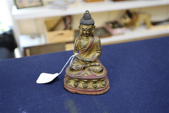 A Sino-Tibetan gilt and polychrome bronze seated figure of Buddha Shakyamuni, 17th/18th century, H. 16.5cm